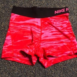 red and pink nike pros